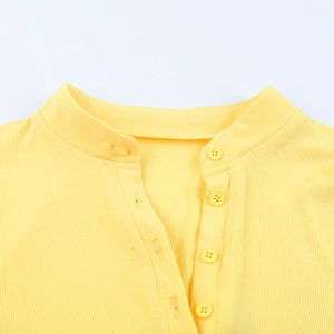 Close-up of yellow ribbed knit bodysuit featuring high collar and matching buttons
