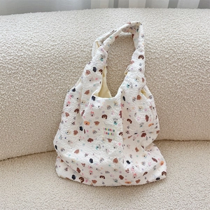 Close-up of white bubble fabric shoulder bag featuring cute dog prints and stars