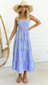 Détail de robe d'été à rayures bleues et blanches avec bustier froncé et jupe à volants