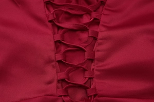 Detailed view of the lace-up back design on a burgundy satin evening gown