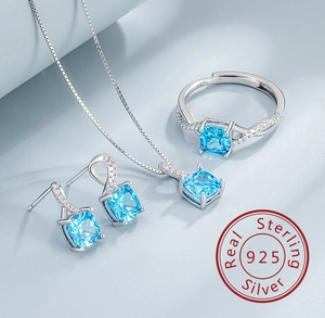Macro detail of S925 sterling silver jewelry set featuring blue square cut gemstones