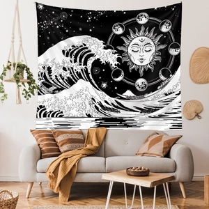 Detail of artistic black and white sun and moon phase tapestry on a minimalist wall