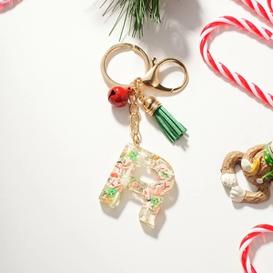 Detail of Christmas resin letter R keychain with miniature Santa and tree inside