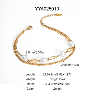 Close-up of double-layer golden stainless steel anklet with white pearl and hex charms