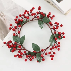 Artificial Christmas wreath with red berries and green pine leaves on white background