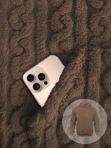 Close-up of coffee brown fleece hoodie fabric texture and functional side pockets