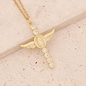 Macro view of a 18K gold-plated cross pendant with wings and inlaid zircons