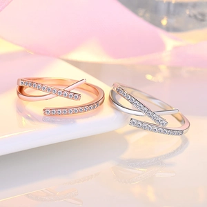 Macro shot of rose gold and silver hollowed crisscross rings with sparkling stones