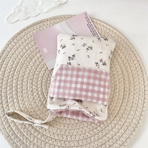 Detail of floral and pink checkered nurse pocket organizer with snap button strap