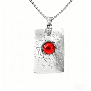 Pendentif vintage en acier inoxydable avec pierre rouge sphérique et texture craquelée