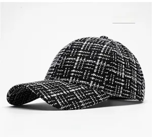 Detail view of the black and white tweed texture on a classic baseball cap