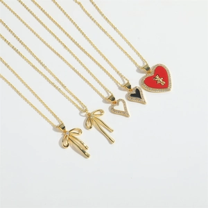 Classic gold French style necklace set featuring zircon inlaid hearts and ribbon pendants