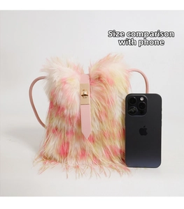 Size comparison of fluffy faux fur crossbody bag next to a smartphone device