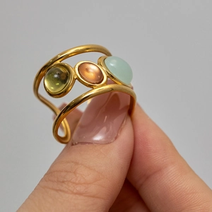 Macro detail of French retro gold adjustable ring featuring tri-color natural stones