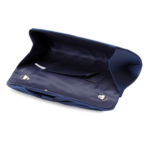 Interior detail of navy blue fabric clutch bag featuring side pocket and metal D-rings