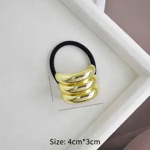 Macro view of gold U-shaped alloy ponytail holder with dimension 4cm x 3cm and 15g weight