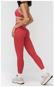 Detail view of red yoga set showing high waist leggings and thin strap sports bra for fitness