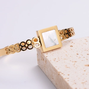 Elegant gold-plated geometric hollow bangle with square mother of pearl inlay