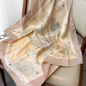 Detailed texture of silk square scarf with brown polka dots on a vintage wooden chair