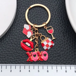 Cartoon XOXO keychain with red heart, lips and handbag charms on a gold-plated link chain