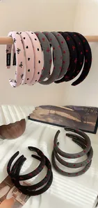 Close-up of padded headbands featuring heart patterns and 'Hand Made' interior label