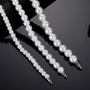 Three sizes of white faux pearl bag chains with silver screw clasps on a black surface
