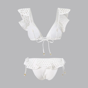 Detail of white crochet ruffle bikini set with lace embroidery and golden drawstring tips