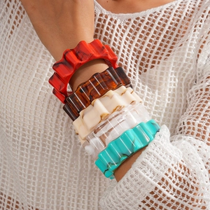 Macro shot of colorful wavy acrylic bangles showcasing vibrant resin textures and design