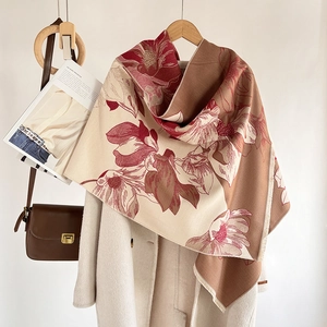 Elegant magnolia cashmere scarf with tassels hanging on a hanger in a stylish setup