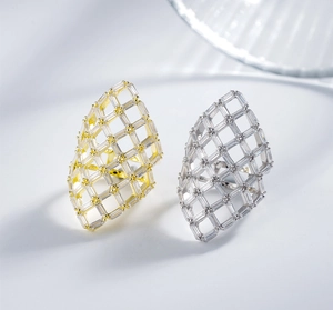 Detailed macro shot of镂空 grid pattern ring with shimmering rectangular zircons in gold and silver
