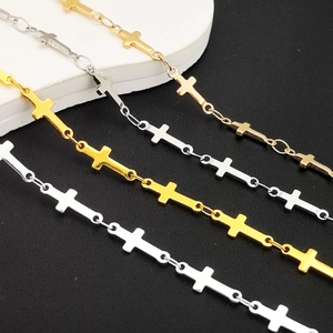 Detail shot of gold and silver metallic cross link chains on white and black background