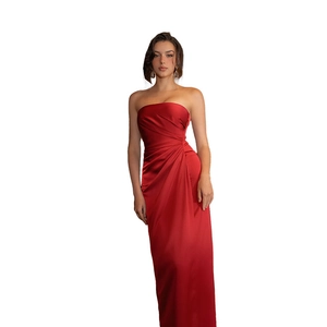 Detailed view of red strapless satin evening dress featuring elegant draped silhouette