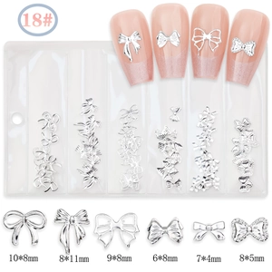 Detailed view of silver alloy bow nail charms in six styles with size specifications