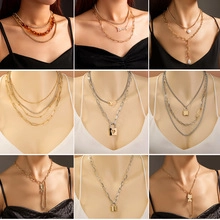 Detailed grid showing multiple layered gold and silver necklaces with diverse pendants