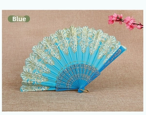 Detailed view of blue Chinese folding fan with gold lace patterns and carved ribs