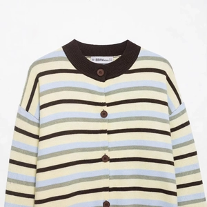 Striped knit polo shirt with color-block beige, blue, and brown patterns and front buttons