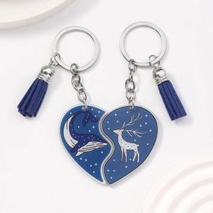 Matching heart acrylic keychain set featuring whale and reindeer patterns with blue tassels