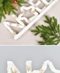 Detailed close-up of woven cotton texture and wooden stars on Nordic NOEL holiday decor