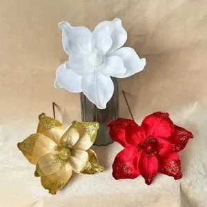 Detailed view of handmade velvet Christmas flowers in red, gold, and white colors