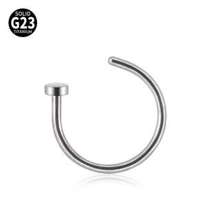 Macro detail of silver C-shaped G23 titanium nose ring with flat disc and high polish
