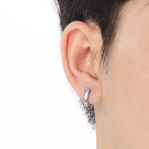 Silver titan steel hoop earring with iridescent zircon shown on a male model's ear