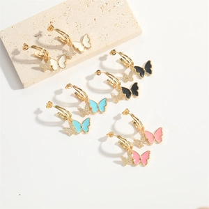 Dopamine bow earrings with gold hoops and colorful enamel butterflies in four colors