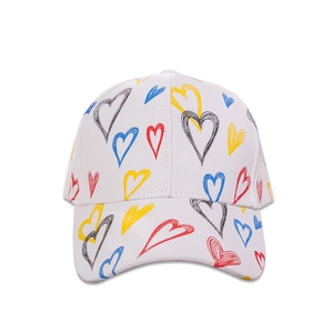 Detail of white cotton baseball cap featuring colorful graffiti heart print and curved brim