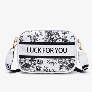 Chic white camera crossbody bag featuring black floral toile print and Luck For You text