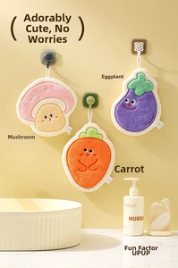 Hanging coral fleece vegetable-shaped hand towels showing mushroom, carrot, and eggplant designs