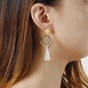 Modern geometric bicolor titanium drop earrings with gold and silver metal charms