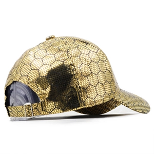 Golden baseball cap with metallic honeycomb texture and adjustable buckle on white background