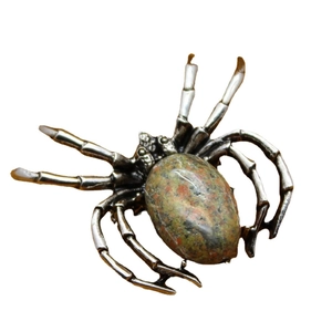 Silver spider brooch with oval goldstone pendant shown on a clean white background