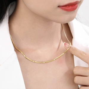 Golden flat snake chain necklace in titanium steel with intricate cross star patterns
