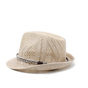 Detail of beige hollow-knit fedora hat featuring a tricolor band and leather buckle